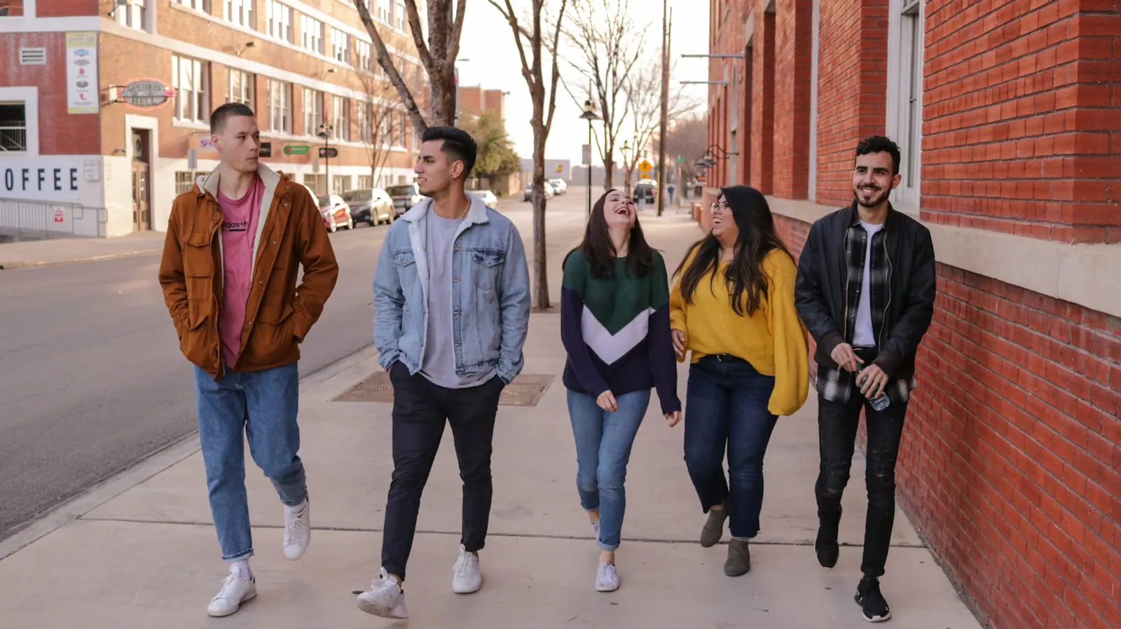 A diverse group of students walking and laughing together.